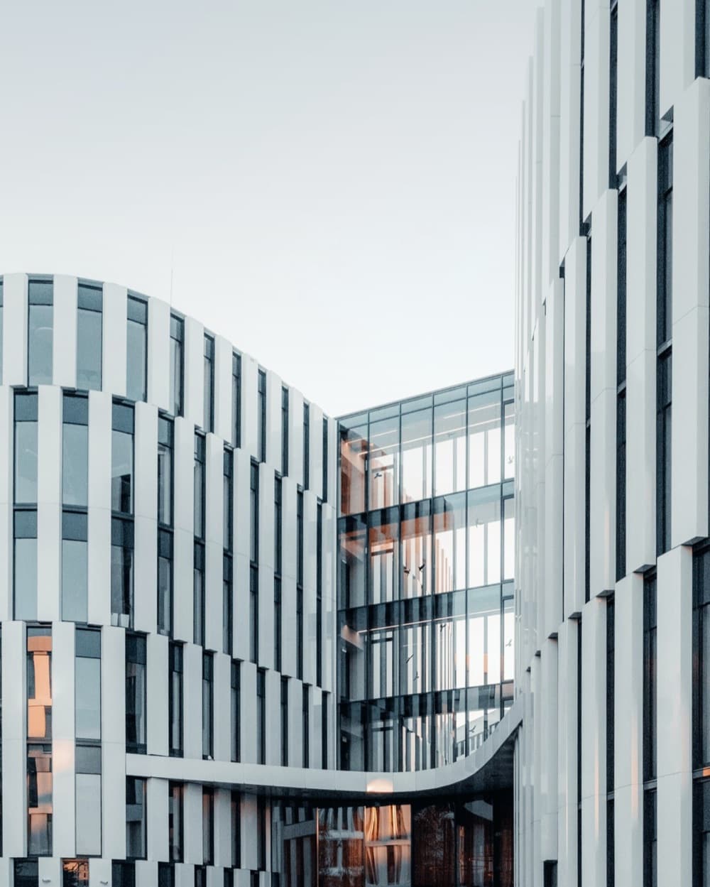Curved office building with a light facade
